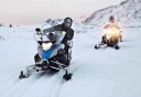Photo of guests riding single snowmobiles